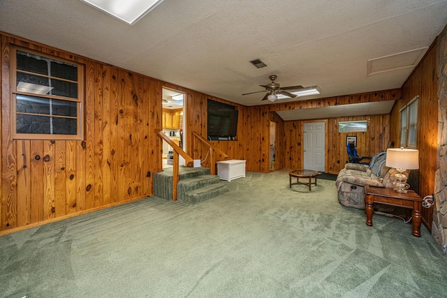 2567 Mona Ave, Charleston, SC 29414 - carpeted living room featuring wood walls, a textured ceiling, stairway, attic access, and ceiling fan