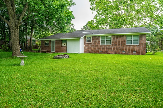 2567 Mona Ave, Charleston, SC 29414 - rear view of property featuring crawl space, a lawn, an outdoor fire pit, and brick siding