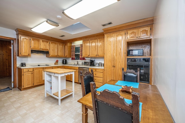 2567 Mona Ave, Charleston, SC 29414 - kitchen featuring black appliances, a sink, under cabinet range hood, light flooring, and butcher block countertops