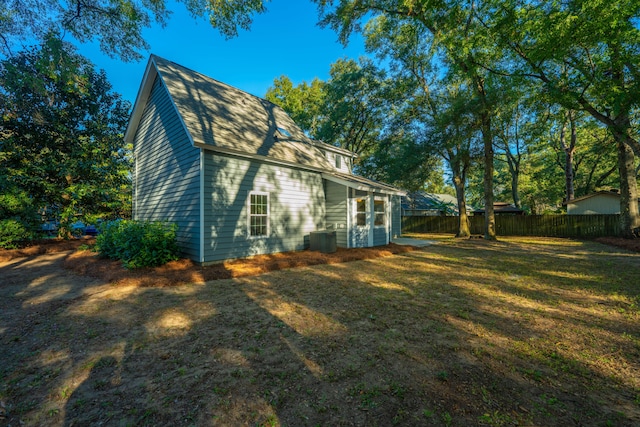 view of side of home with a lawn