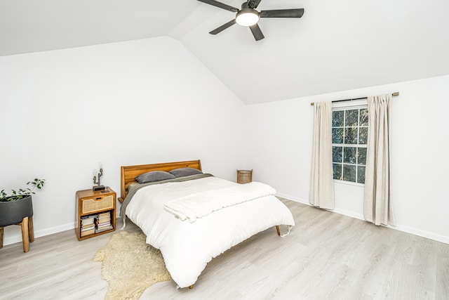 bedroom featuring ceiling fan, vaulted ceiling, and light wood-type flooring