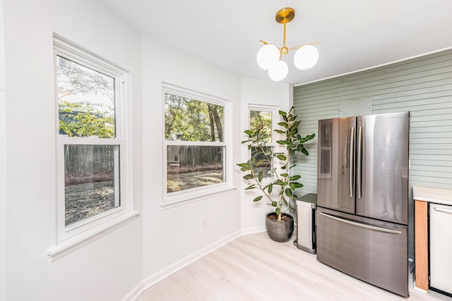 kitchen with stainless steel refrigerator, dishwasher, a healthy amount of sunlight, and light hardwood / wood-style floors