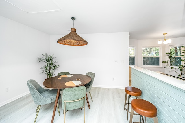 dining room featuring a notable chandelier and light wood-type flooring