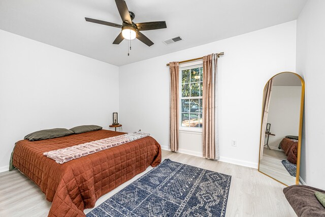 bedroom with ceiling fan and light wood-type flooring