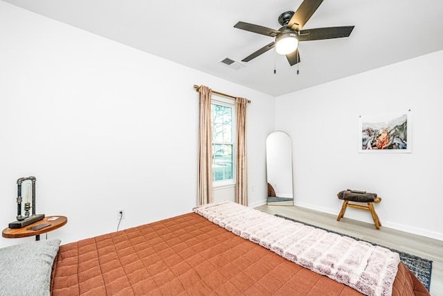 bedroom with hardwood / wood-style flooring and ceiling fan