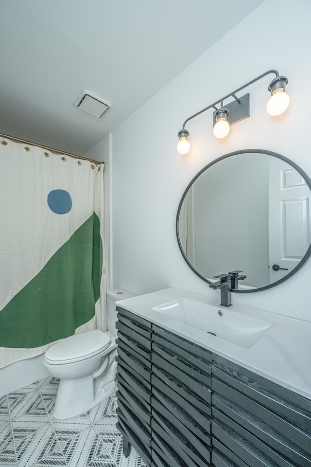 bathroom featuring vanity and toilet