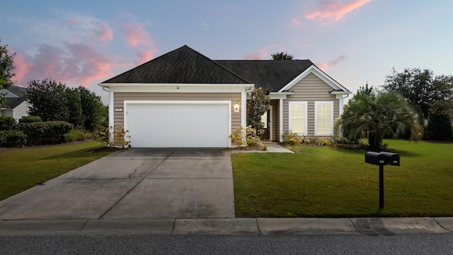 view of front facade featuring a garage and a yard