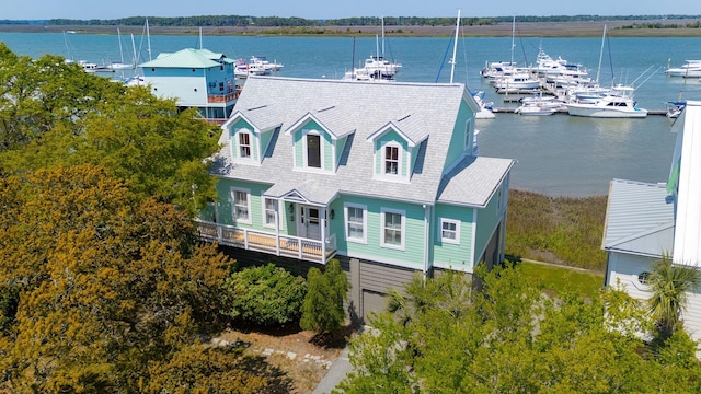 68 W 9th St Unit B, Folly Beach, SC 29439 - view of front of house featuring a garage, a shingled roof, and a water view