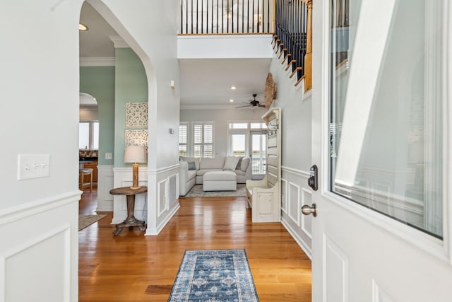 68 W 9th St Unit B, Folly Beach, SC 29439 - entryway with arched walkways, wood finished floors, a decorative wall, and crown molding