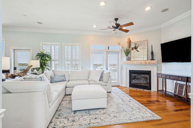 68 W 9th St Unit B, Folly Beach, SC 29439 - living room featuring a fireplace with flush hearth, recessed lighting, wood finished floors, crown molding, and ceiling fan