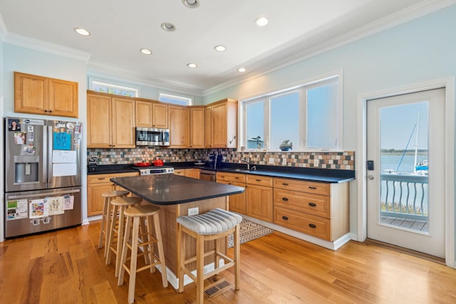 68 W 9th St Unit B, Folly Beach, SC 29439 - kitchen with dark countertops, ornamental molding, and appliances with stainless steel finishes