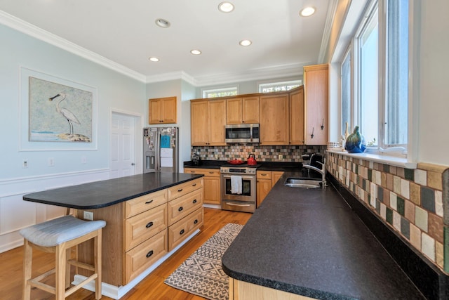 68 W 9th St Unit B, Folly Beach, SC 29439 - kitchen featuring dark countertops, appliances with stainless steel finishes, a kitchen breakfast bar, and a sink