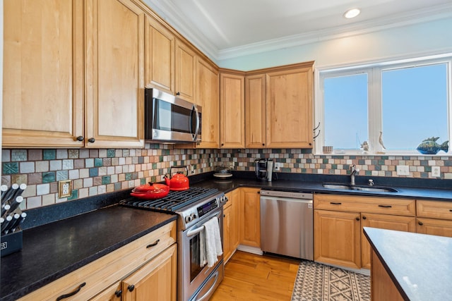 68 W 9th St Unit B, Folly Beach, SC 29439 - kitchen with stainless steel appliances, dark countertops, ornamental molding, a sink, and tasteful backsplash