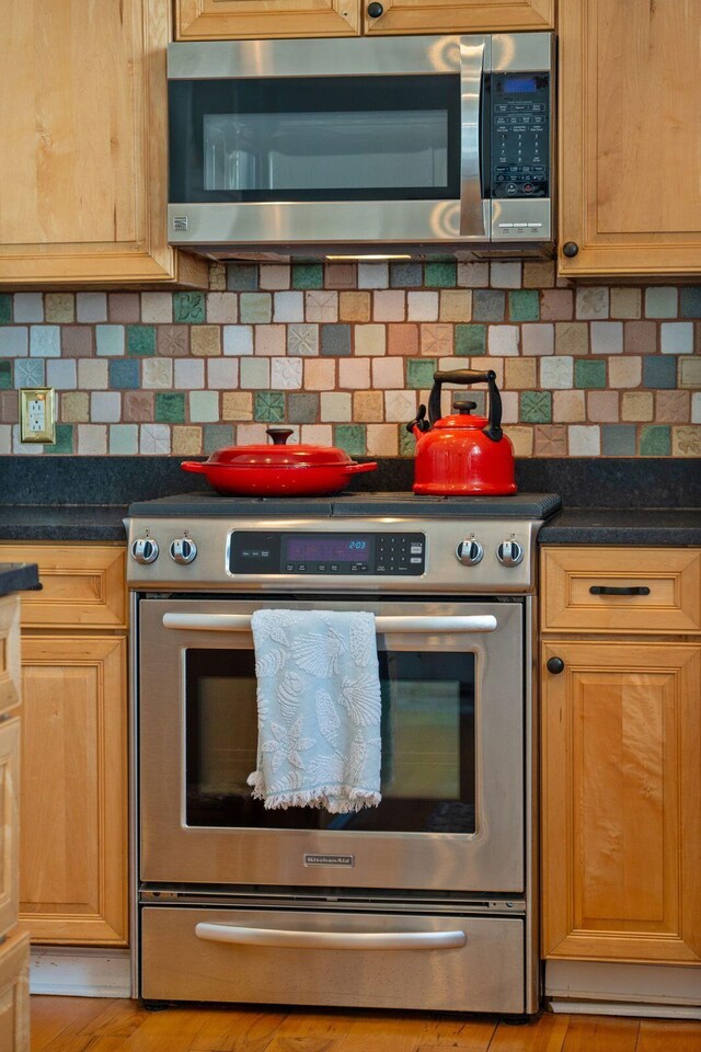68 W 9th St Unit B, Folly Beach, SC 29439 - kitchen with dark countertops, tasteful backsplash, and appliances with stainless steel finishes