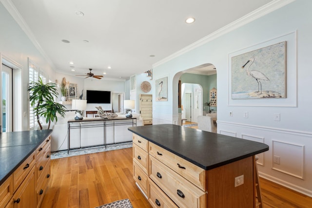 68 W 9th St Unit B, Folly Beach, SC 29439 - kitchen with ceiling fan, arched walkways, dark countertops, and crown molding