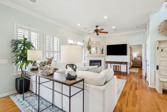 68 W 9th St Unit B, Folly Beach, SC 29439 - living room with light wood-type flooring, a glass covered fireplace, recessed lighting, ceiling fan, and crown molding
