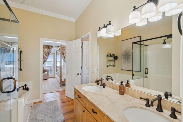 68 W 9th St Unit B, Folly Beach, SC 29439 - ensuite bathroom featuring ornamental molding, wood finished floors, a sink, and a stall shower
