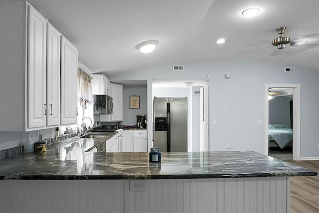 kitchen with white cabinetry, stainless steel refrigerator with ice dispenser, sink, kitchen peninsula, and lofted ceiling