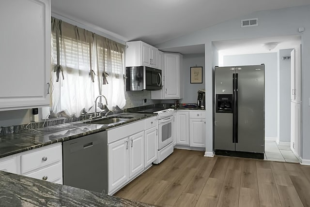 kitchen with dishwasher, white cabinetry, stainless steel refrigerator with ice dispenser, white range with electric stovetop, and vaulted ceiling