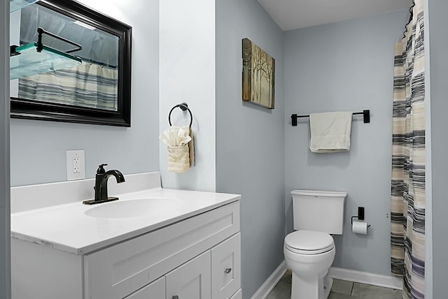 bathroom with vanity, toilet, and tile patterned flooring