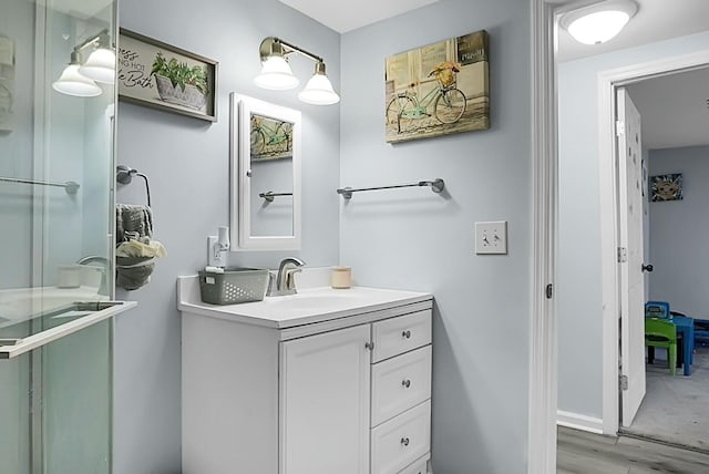 bathroom featuring vanity, hardwood / wood-style flooring, and walk in shower