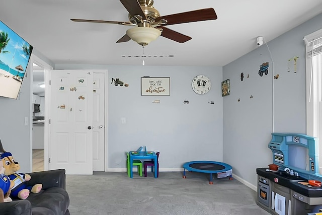 interior space with ceiling fan and carpet flooring