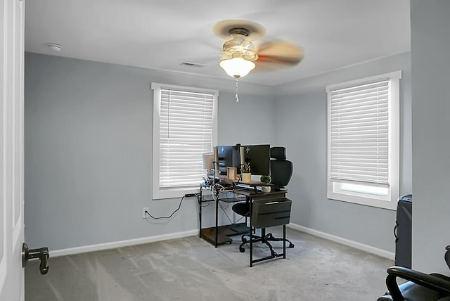 office with ceiling fan, light colored carpet, and a healthy amount of sunlight