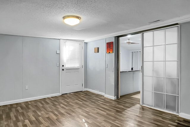 foyer featuring a textured ceiling and dark hardwood / wood-style flooring