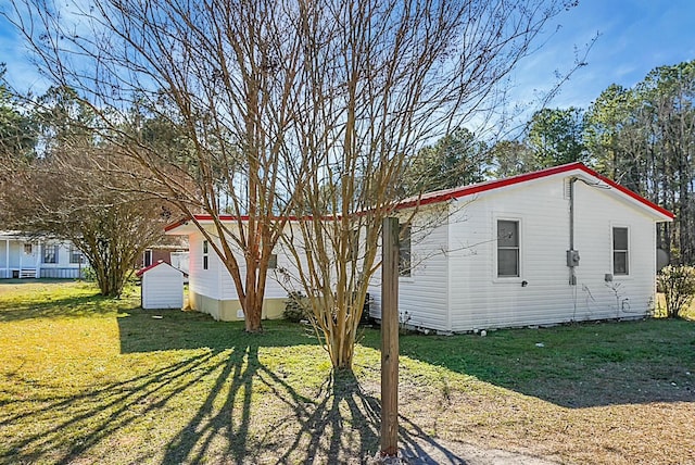 view of side of property with a yard