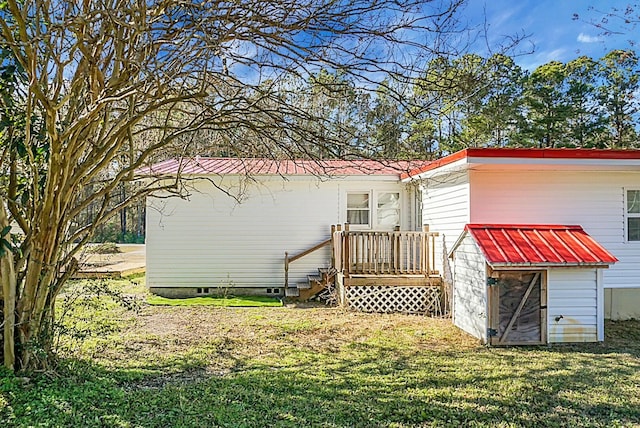 back of property with a lawn