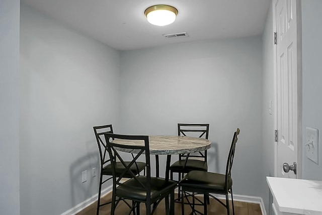 dining area with dark wood-type flooring