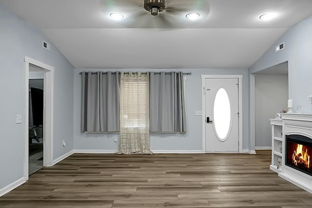 foyer entrance with dark hardwood / wood-style flooring and lofted ceiling