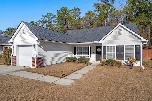 ranch-style home with a garage, a front lawn, and covered porch