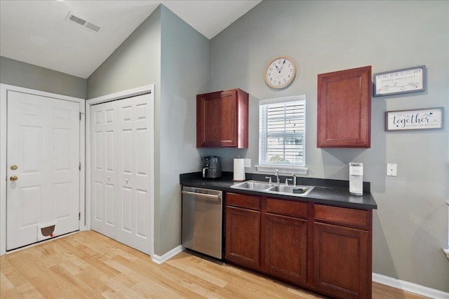 kitchen featuring lofted ceiling, sink, stainless steel dishwasher, and light hardwood / wood-style flooring