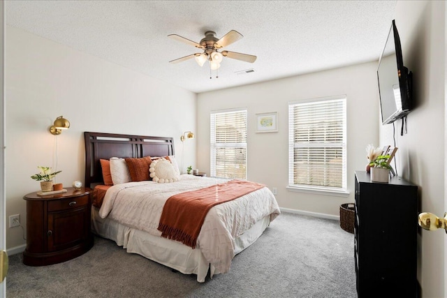 bedroom featuring ceiling fan, carpet flooring, and a textured ceiling