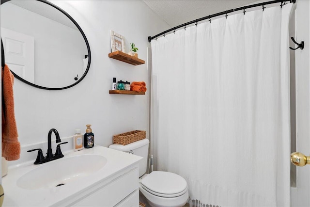 bathroom featuring vanity, toilet, and a textured ceiling