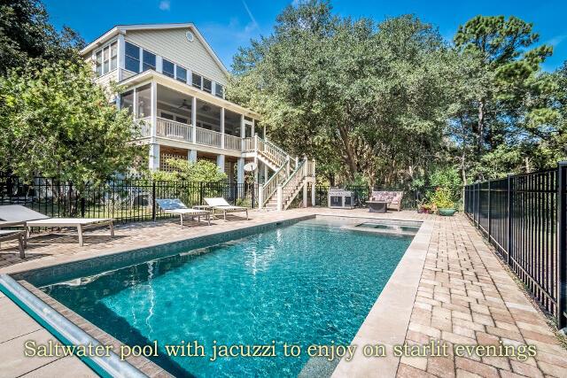 view of swimming pool with a hot tub, a patio, and a sunroom