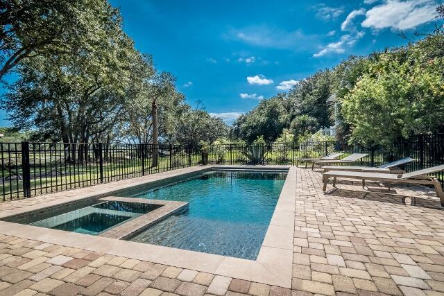 view of pool featuring an in ground hot tub and a patio area