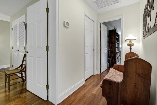 hallway with hardwood / wood-style flooring