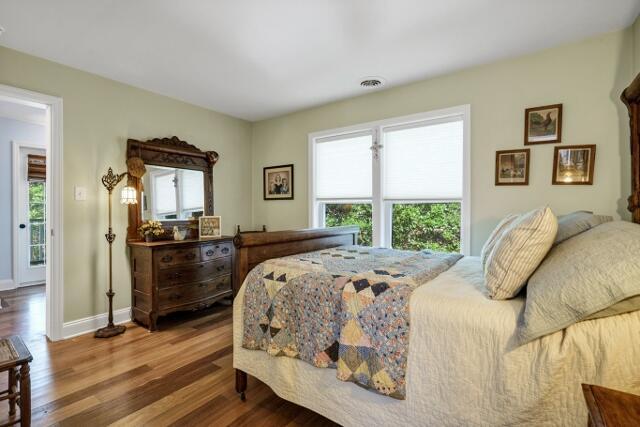 bedroom featuring hardwood / wood-style flooring and multiple windows