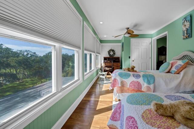 bedroom featuring crown molding, ceiling fan, and dark hardwood / wood-style floors