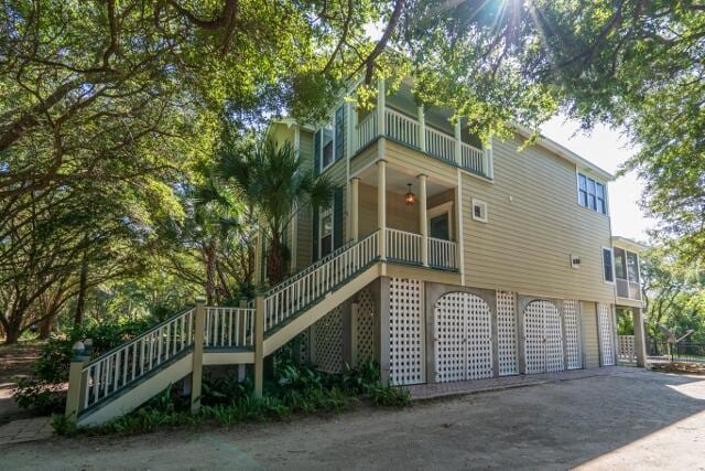 back of house with a garage and a balcony