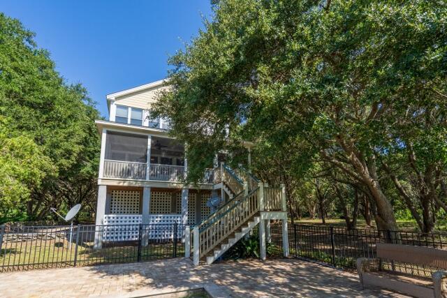 rear view of house featuring a sunroom