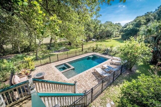 view of pool featuring a lawn and an outdoor fire pit