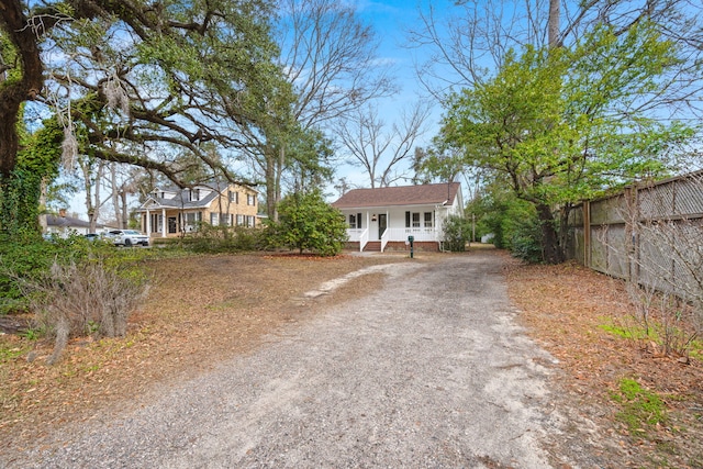 view of front of house with driveway and fence