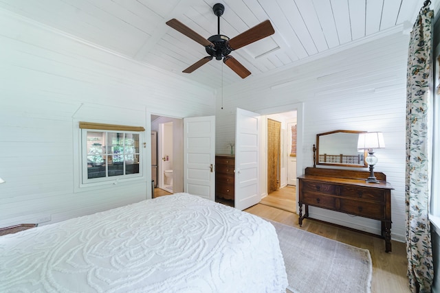 bedroom with ceiling fan, light hardwood / wood-style flooring, ensuite bathroom, and wooden ceiling