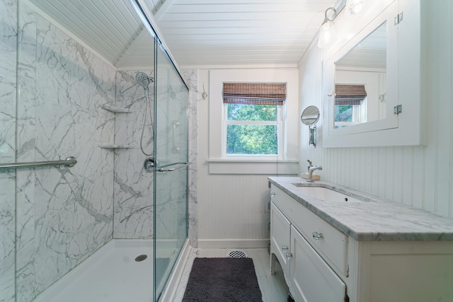 bathroom featuring tile patterned floors, a shower with door, and vanity