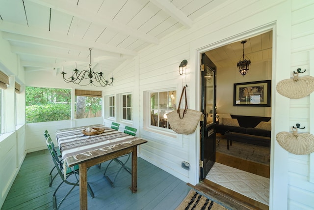 sunroom / solarium featuring vaulted ceiling with beams and wood ceiling