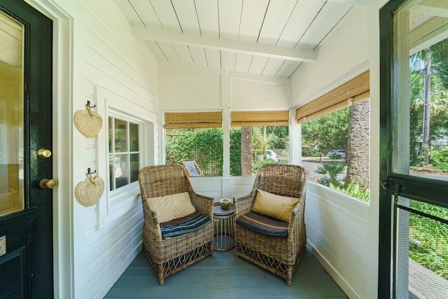 sunroom featuring lofted ceiling with beams and wooden ceiling