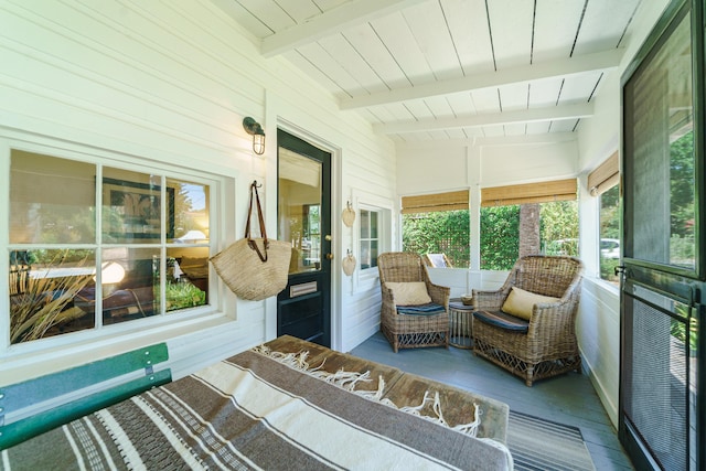 sunroom featuring vaulted ceiling with beams and wood ceiling